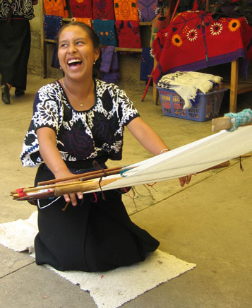 In Mexico's state of Chiapas, a smiling lady weaves hand-made cloth.